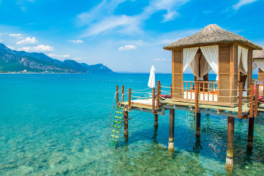 Wooden beach pavilions on the shore of a sandy beach
