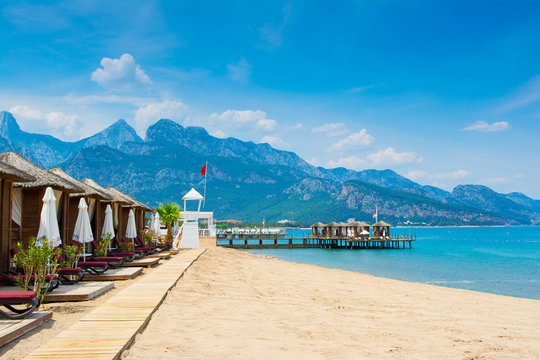 Wooden beach pavilions on the shore of a sandy beach