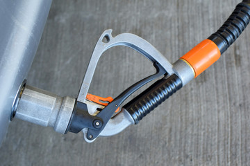Autogas nozzle fueling car with lpg autogas at petrol station. Car refuel CNG gas in gasoline...