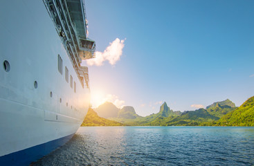 Side view of anchored cruise ship at sunset. Mountain background. - obrazy, fototapety, plakaty