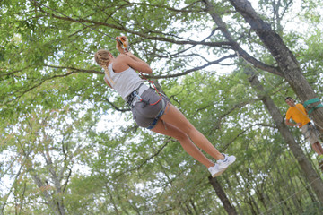 beautiful girl in the park on the ropes achieve outdoors