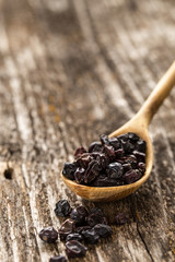 Spoon of barberry on a wooden background. 