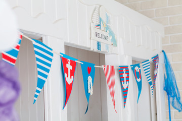 Baby's room in a nautical style. Marine interior for children. Door decoration with flags and...