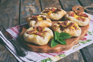 Mini pies made of puff pastry, custard and caramelized rhubarb. Homemade baking. Delicious freshly baked cookies. Rustic photo