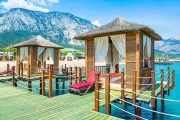 Wooden beach pavilions on the shore of a sandy beach