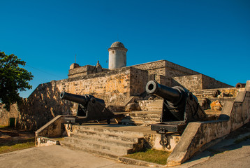 Old weathered cannons and shots exposition near the walls of Jagua fortress Fortaleza de Jagua....
