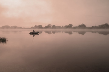 Obraz na płótnie Canvas Morning on a river with fog, fishing, vintage view