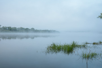 Morning on a river with fog, fishing