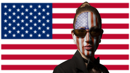 Portrait of woman with painted USA flag and sunglasses