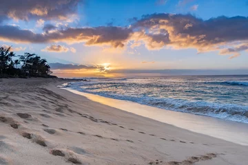 Foto op Aluminium Sunset over Sunset Beach on the North Shore of Oahu, Hawaii with palm trees and surf rolling in on the sandy beach © Nancy Anderson