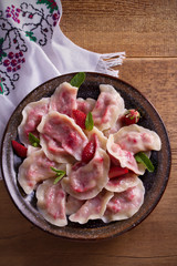 Dumplings, filled with strawberries, berries. Pierogi, varenyky, vareniki, pyrohy - dumplings with filling, popular dish in many countries. overhead, vertical