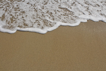 Fototapeta na wymiar Sea Foam Waves on the Beach
