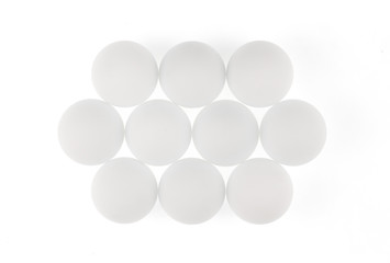 white abstract balls, eggs, geometric shapes, white background