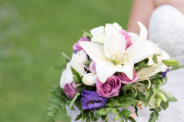 Wedding rings lie on a beautiful colorful bouquet