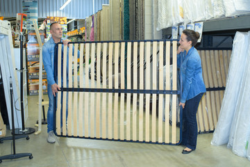 couple carrying bed frame support