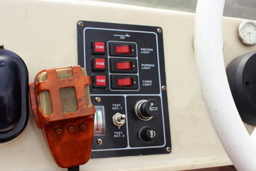 Boat equipment – microphone siren and switch panel white motor boats closeup