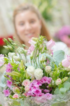 Closeup of bouquet of flowers, woman in background