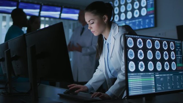 Female Scientist / Neurologist Working on a Personal Computer in Modern Laboratory. Medical Research Scientists Making New Discoveries in the fields of Neurophysiology.