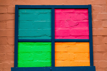 Fototapeta na wymiar frame of colored brick backgrounds on light wall, natural light, copy space, closeup