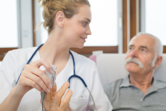 person hands measuring blood sugar with glucometer