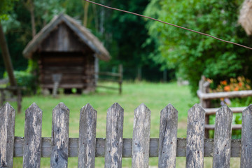 Naklejka premium House behind a wooden fence in a Polish village