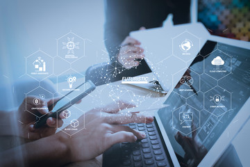 two colleague web designer discussing data and digital tablet docking keyboard and computer laptop with smart phone and design diagram on marble desk,sun light effect