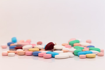 Numerous medicines Medications in the form of tablets. Colored pills on a white background.