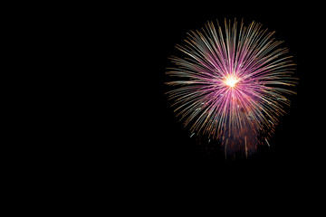 Abstract beautiful colorful fireworks display for celebration on black background with free space for text. New year holiday concept.