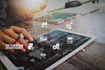 Businessman hand touching digital tablet.Photo finance manager working new Investment project office.Using new technology device.Graphic icons.Strategy business stock exchanges interface 