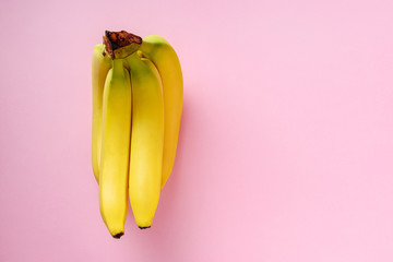 Banana on pink background. Minimal style. Flat lay. Food concept.