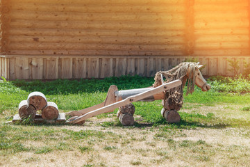 Wooden horse landscape design. Lovingly decorated the area with plants and flowers. Toned