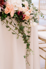 Decoration of a wedding table of newlyweds greens and in flowers