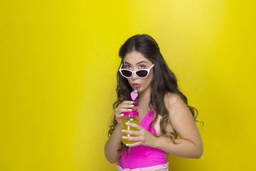  girl with long hair with glasses drinking juice