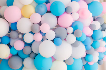Many colorful balloons decorated wall as background