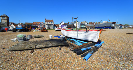 Fototapeta premium Aldeburgh beach with boats and old and new Lifeboat stations with tower.