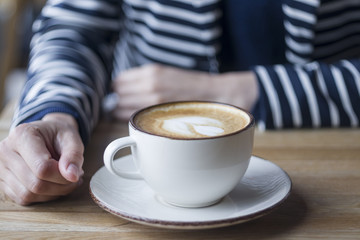 Girl having a break with cup of coffee, close up, soft focus, vintage filter.