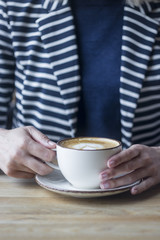 Girl having a break with cup of coffee, close up, soft focus, vintage filter.