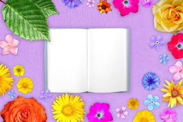 Beautiful flower frame with notepad in center on purple hard leather background. Floral composition of spring or summer flowers.