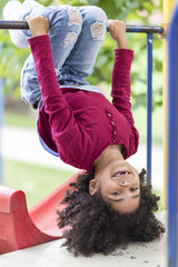 little girl standing upside down in a park