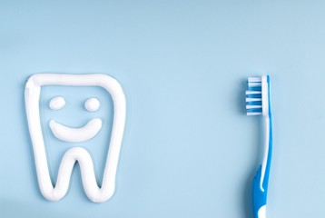 Fototapeta na wymiar Toothbrush and tooth paste on a blue background