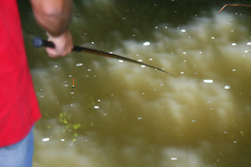 Man fishing in the wild river