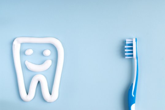 Toothbrush And Tooth Paste On A Blue Background