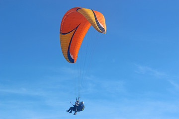 Tandem paraglider flying