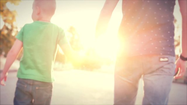 Happy family, Young happy father and son walking with son holding hands. Stock footage