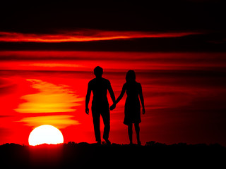 Romantic couple on the sunset with hanging hands