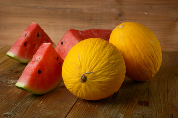 yellow melon and red watermelon on wooden table - sicilian fruit