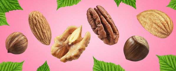 Creative layout made pattern nut mix with leaf Flat lay isolated pink background. Full depth of...