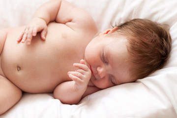 Newborn baby girl sleeping on a summer day at home