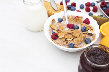 cup of cereals with fruits and milk, balanced and healthy breakfast