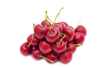 ripe red cherries isolated in white background